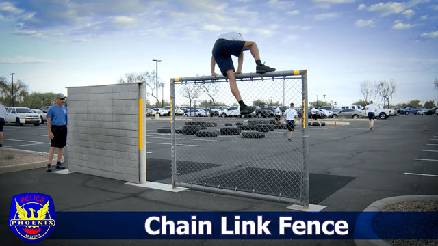 POPAT is a challenging physical test that assesses an individual's ability to perform a chain link fence climb. During the test, participants must demonstrate their proficiency in scaling a chain link fence.