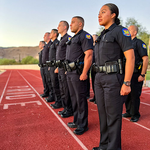 A group of PHX PD police officers standing on a track.