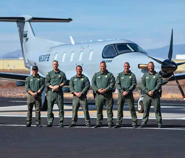 PHX PD pilots standing in front of airplane