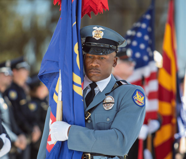 PHX PD officer holding flag